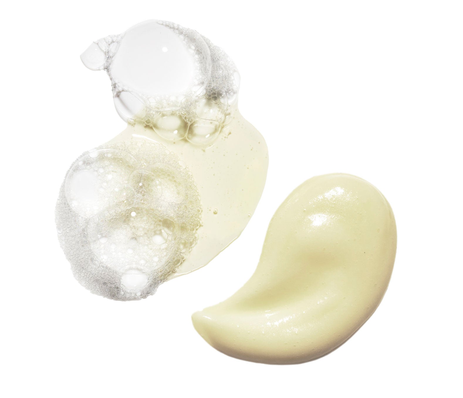 Foaming drop of Hand Wash next to swatch of beige Hand Cream on a white background