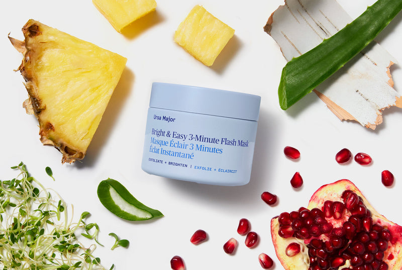 Blue jar of Face Mask surrounded by various botanical elements