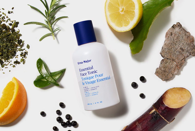 Ursa Major Essential Face Tonic bottle surrounded by natural elements on a white background