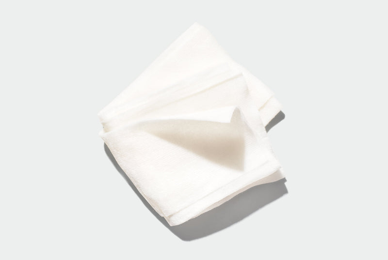 White folded Face Wipe on a light gray background