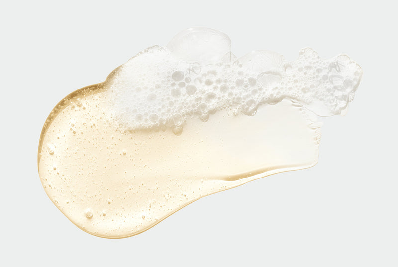 Drop of clear, sudsy Face Wash on white background