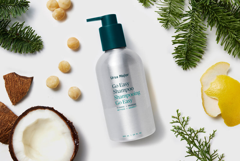 Ursa Major shampoo bottle with natural elements on a white background