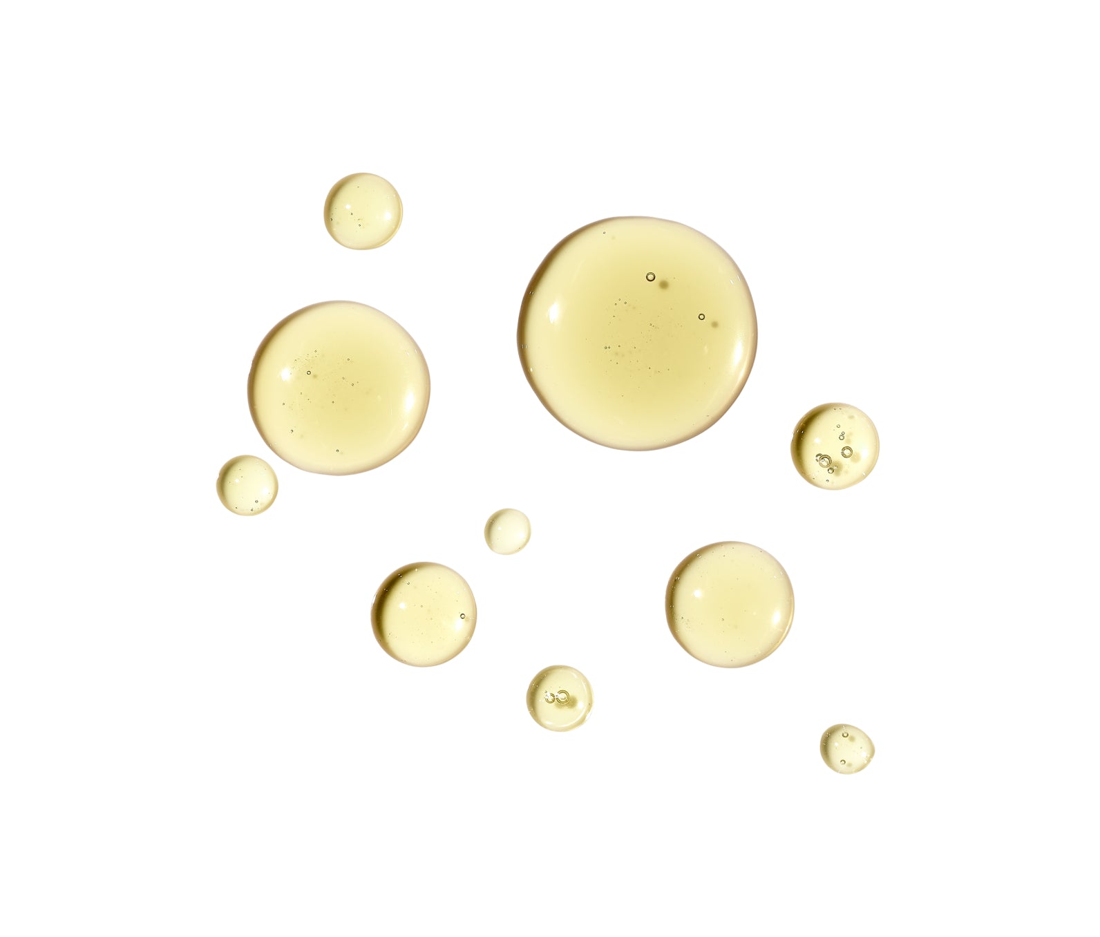 Gold drops of Dry Oil on a white background