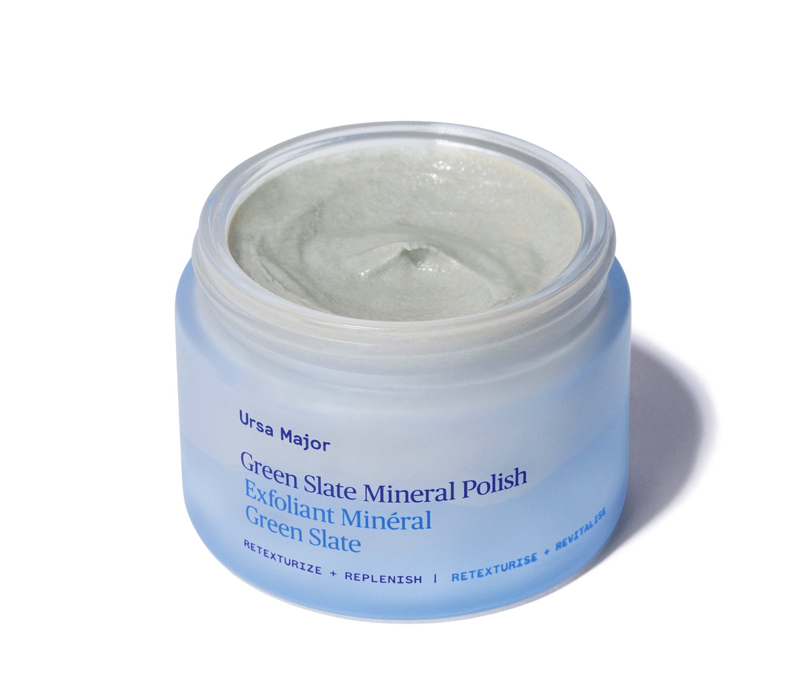 Opened jar of Ursa Major Green Slate Mineral Polish on a white background