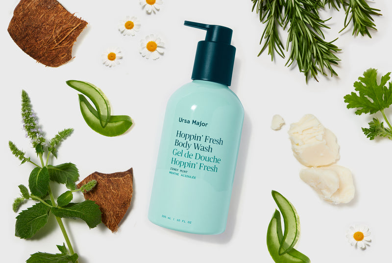 Body wash bottle with natural elements on a light background