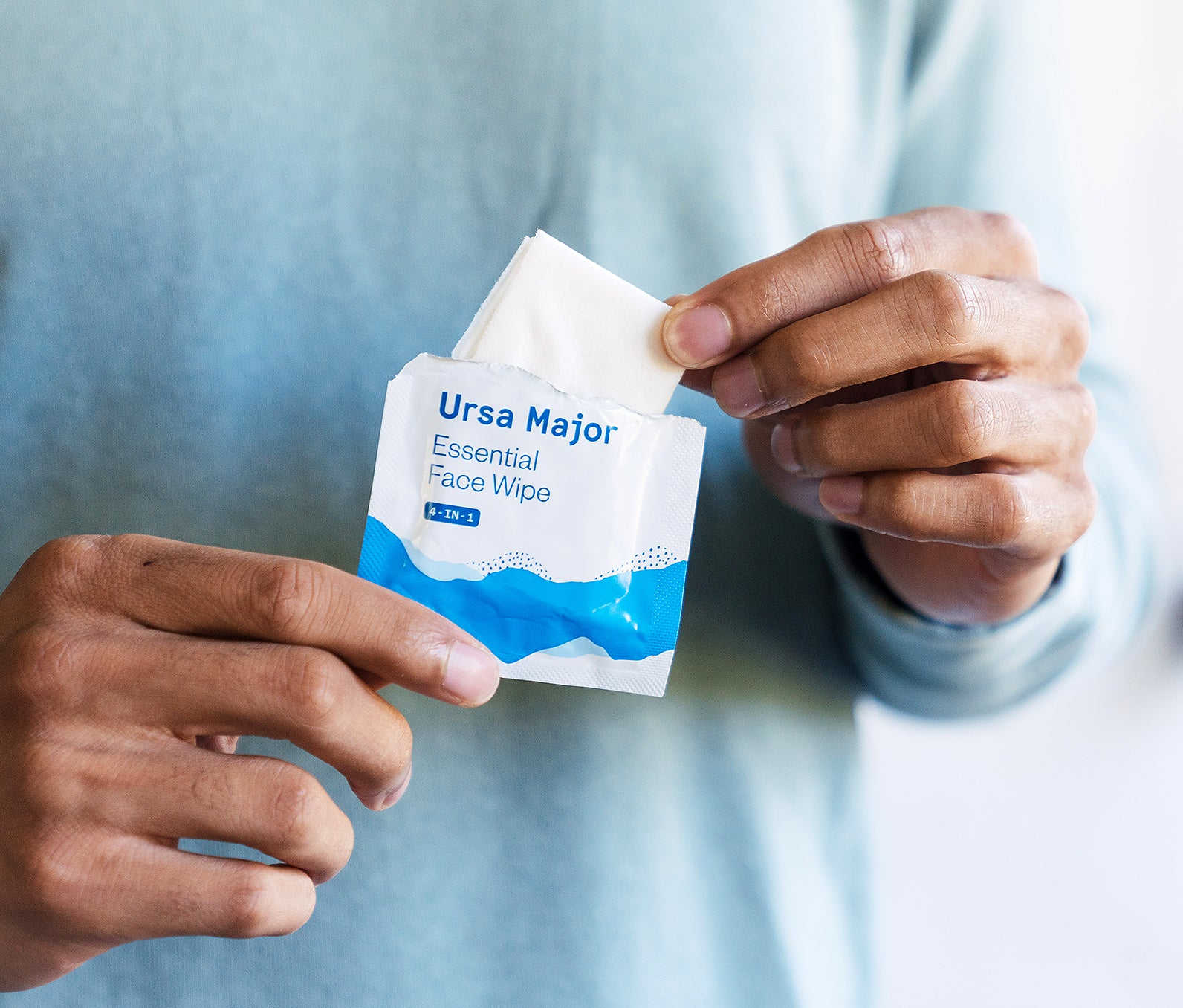 Person opening 4-in-1 Essential Face Wipes by Ursa Major Skincare