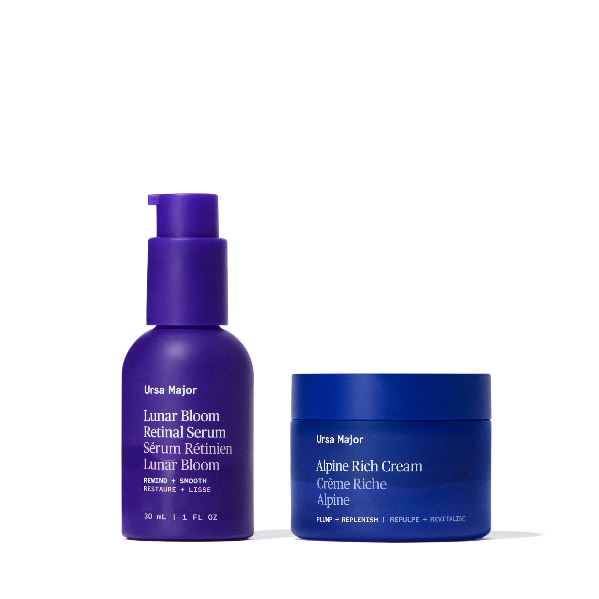 Purple bottle of Ursa Major Lunar Bloom Retinal Serum next to blue jar of Alpine Rich Cream on a white background