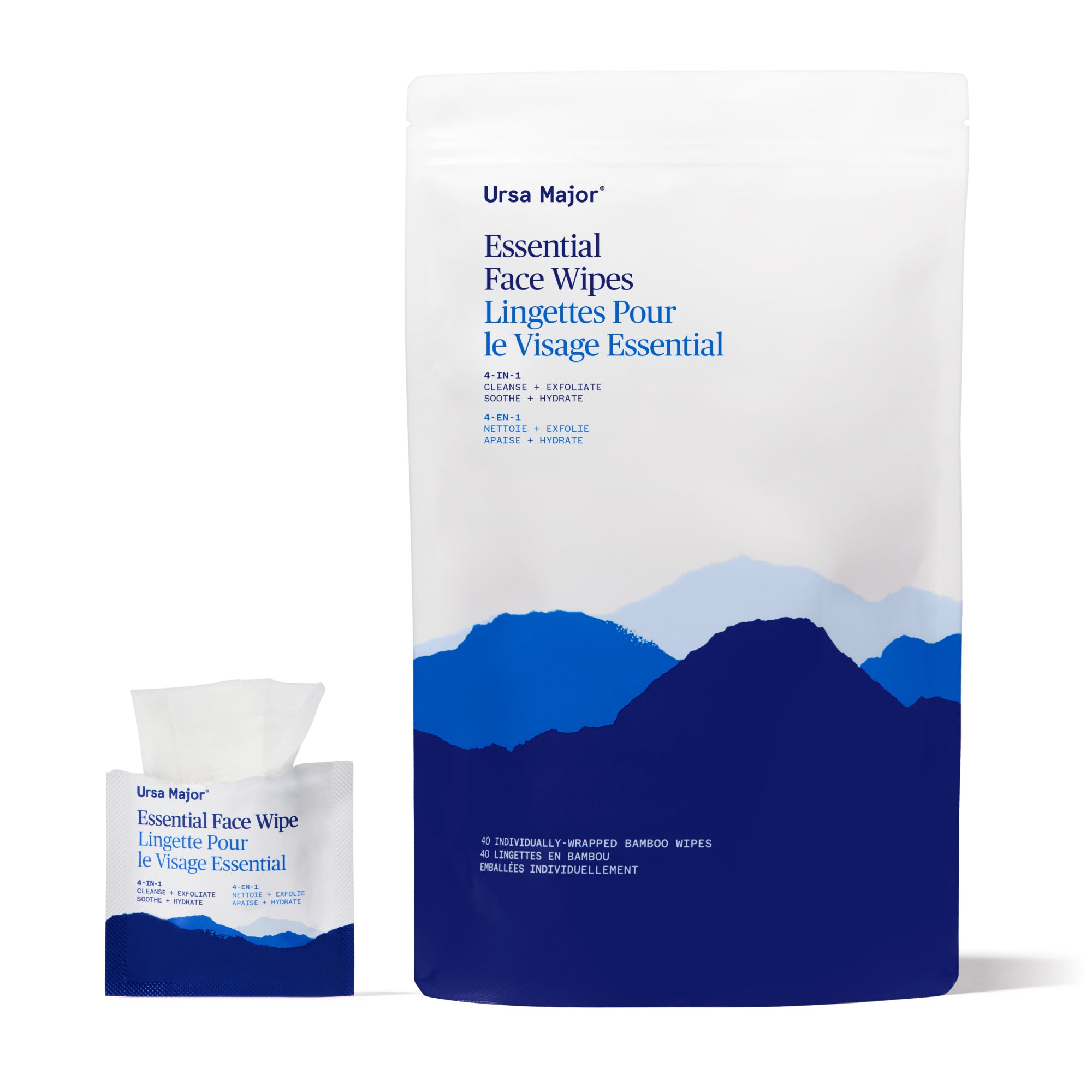 Open packet of Ursa Major Essential Face Wipes, with wipe peeking out of packet, next to a larger pouch with blue mountain design on a white background
