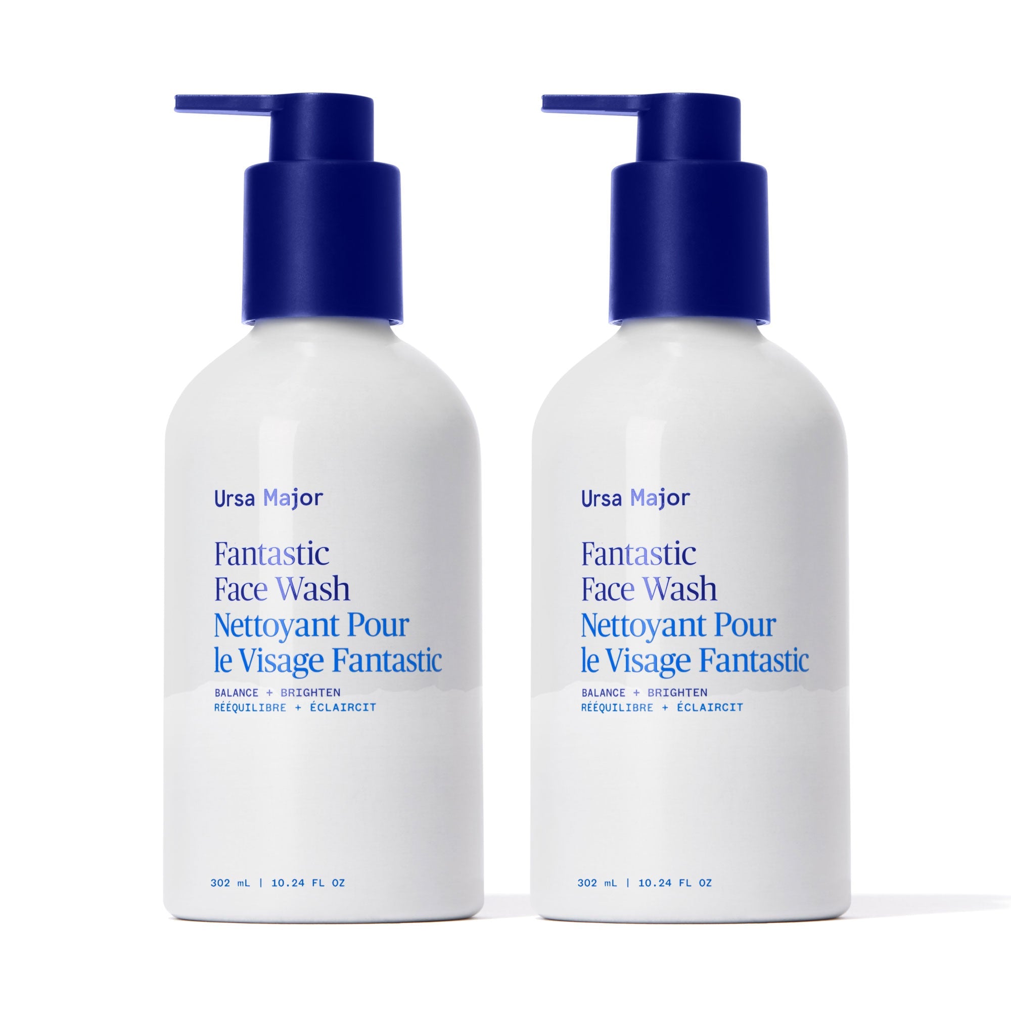 Two white bottles of Ursa Major Fantastic Face Wash with a blue pump on a white background