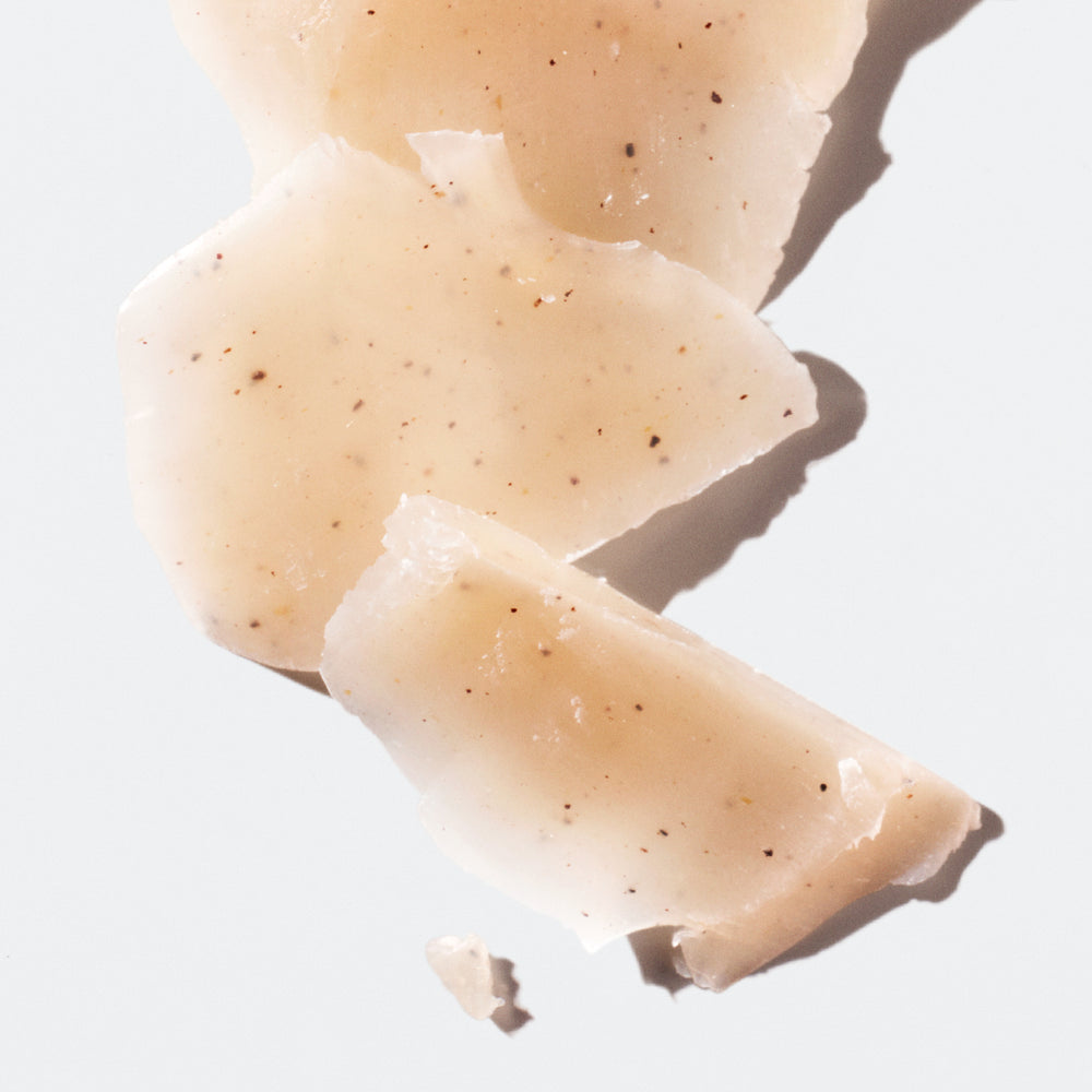 Light-brown chunks of deodorant with flakes of dark-brown in the center on a white background.