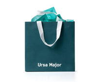 Teal bag with 'Ursa Major' branding, filled with teal tissue paper.