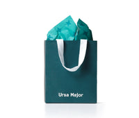 Teal bag with 'Ursa Major' branding, filled with teal tissue paper.