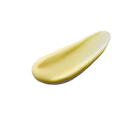 Yellow swipe of Body Serum on a white background