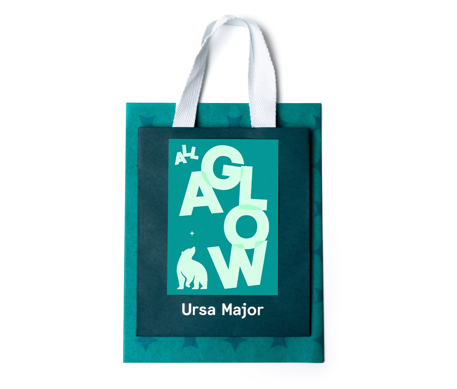 Teal gift bag with 'Ursa Major' on it with a 'All a Glow' card and teal tissue paper on a white background.