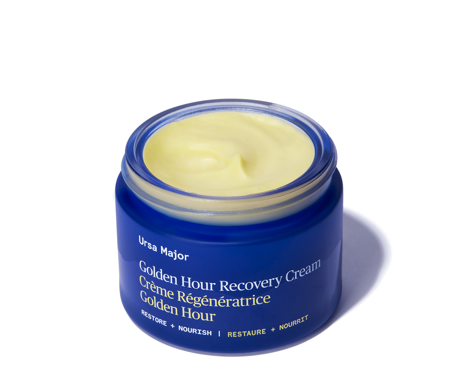 Blue jar of Ursa Major Golden Hour Recovery Cream on a white background
