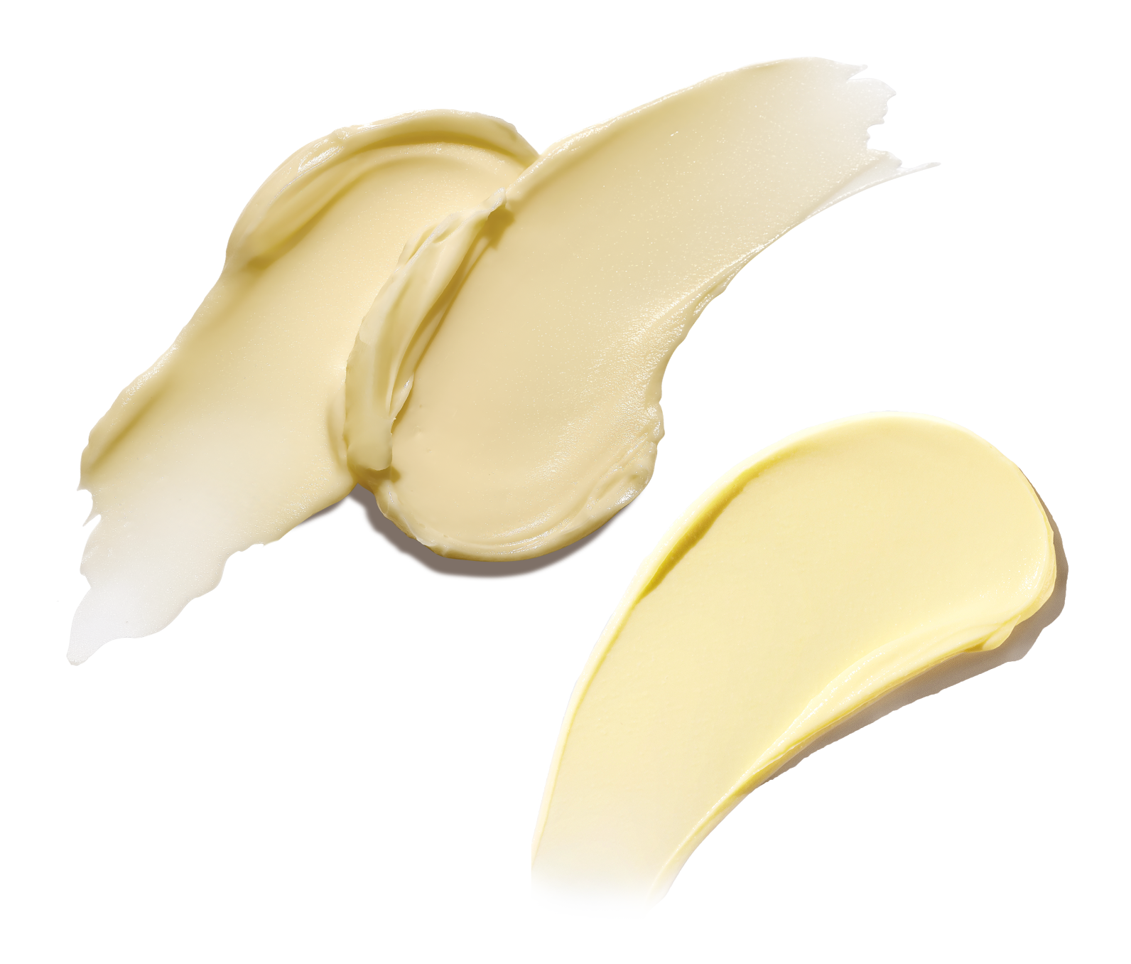Three swatches of light yellow cream on a white background