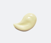 Swipe of Ursa Major Botanic Buzz Hand Cream on a light-gray background.  Hand Cream is light-yellow in color.