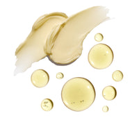 Thick yellow cream next to yellow oil droplets on a white background