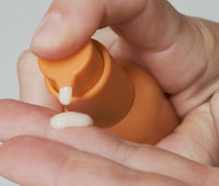 Video of person dispensing a pump of Ursa Major Mountain Glow Serum into palm and smoothing on skin