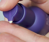 Video of person dispensing a pump of Ursa Major Lunar Bloom Retinal Serum into palm and smoothing on skin
